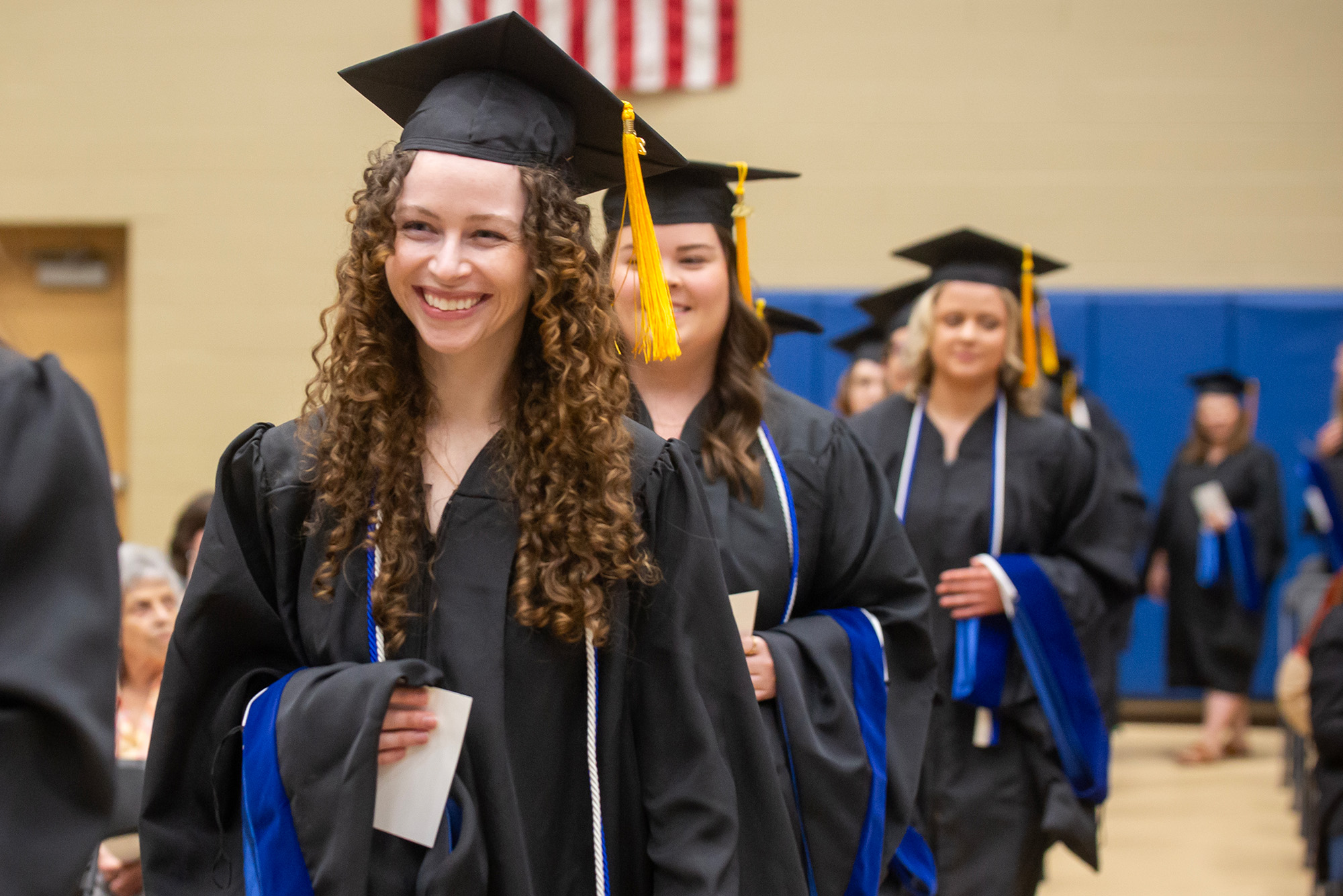 MMU Students wearing cap and gowns at graduation